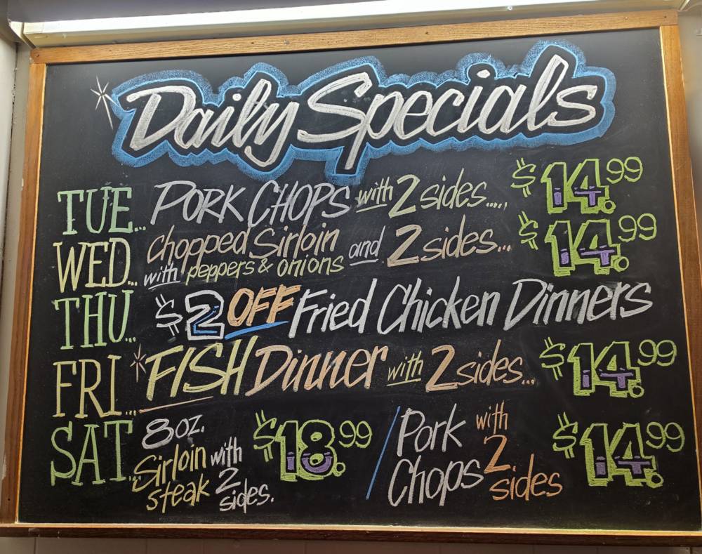 The hand-drawn daily specials chalkboard at Houston Pub