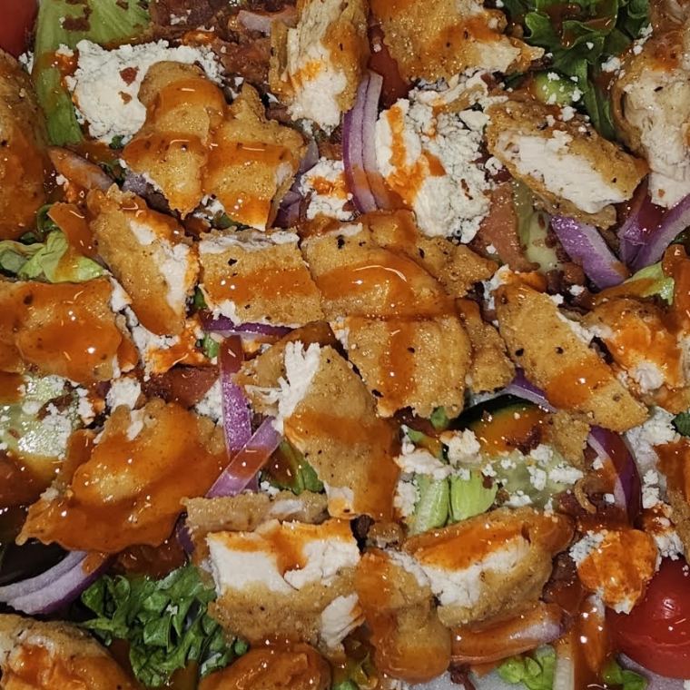 The buffalo chicken salad — breaded chicken in buffalo sauce over mixed greens with bleu cheese crumbles, red onion, tomato and bacon