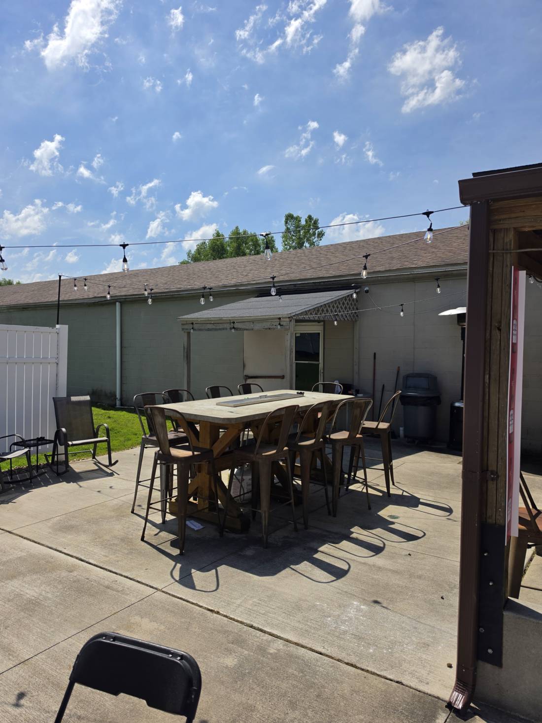 The covered section of the patio — pergola, pass-through window and projection screen