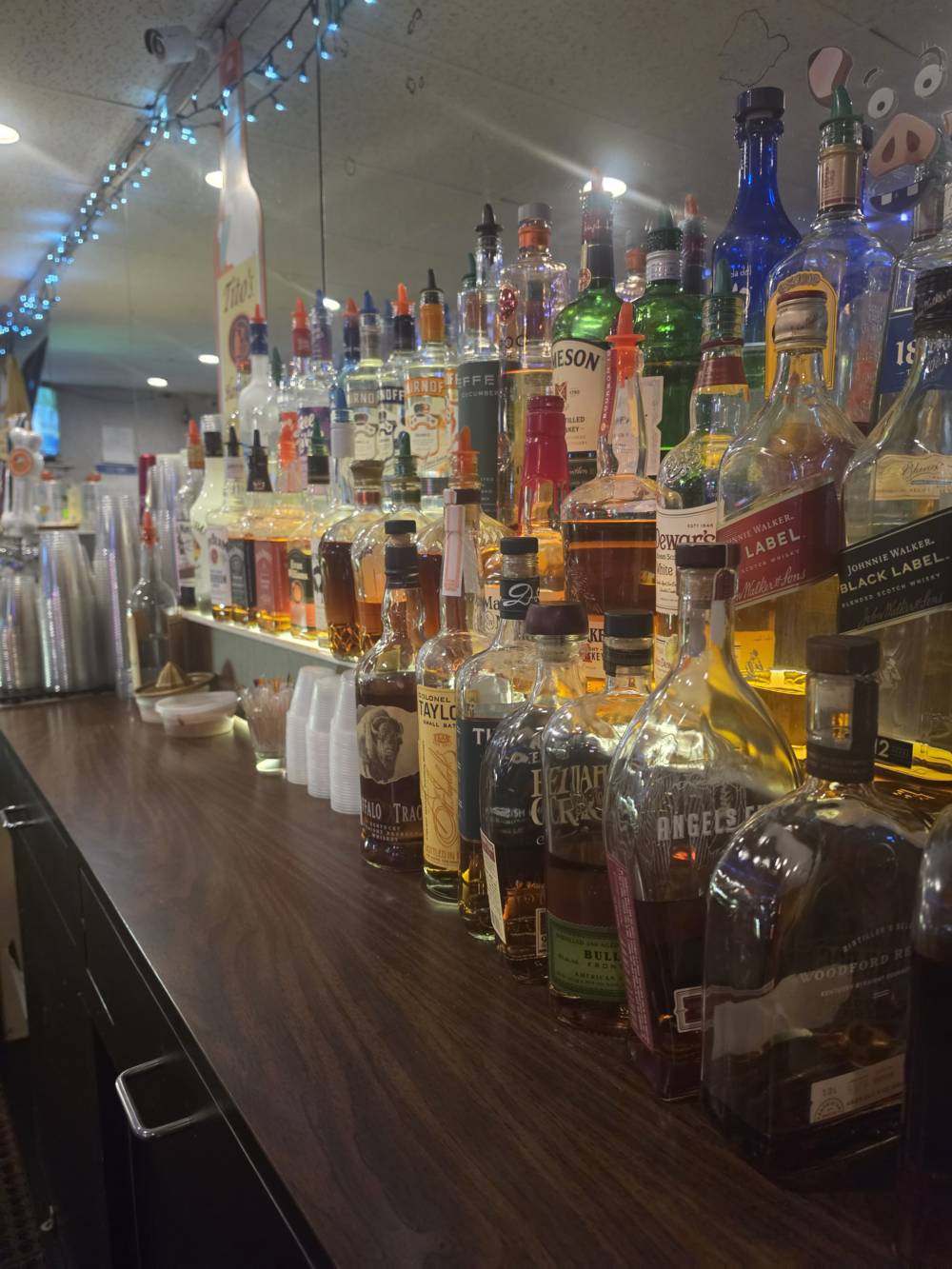 The back-bar whiskey shelf — Buffalo Trace, E.H. Taylor, Woodford Reserve, Angel's Envy, Bulleit and more